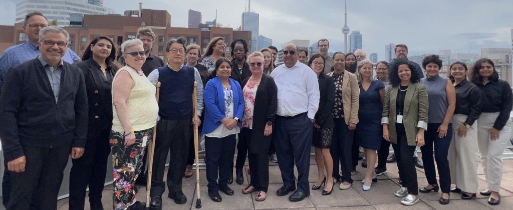 COG staff gathered in front of Toronto skyline
